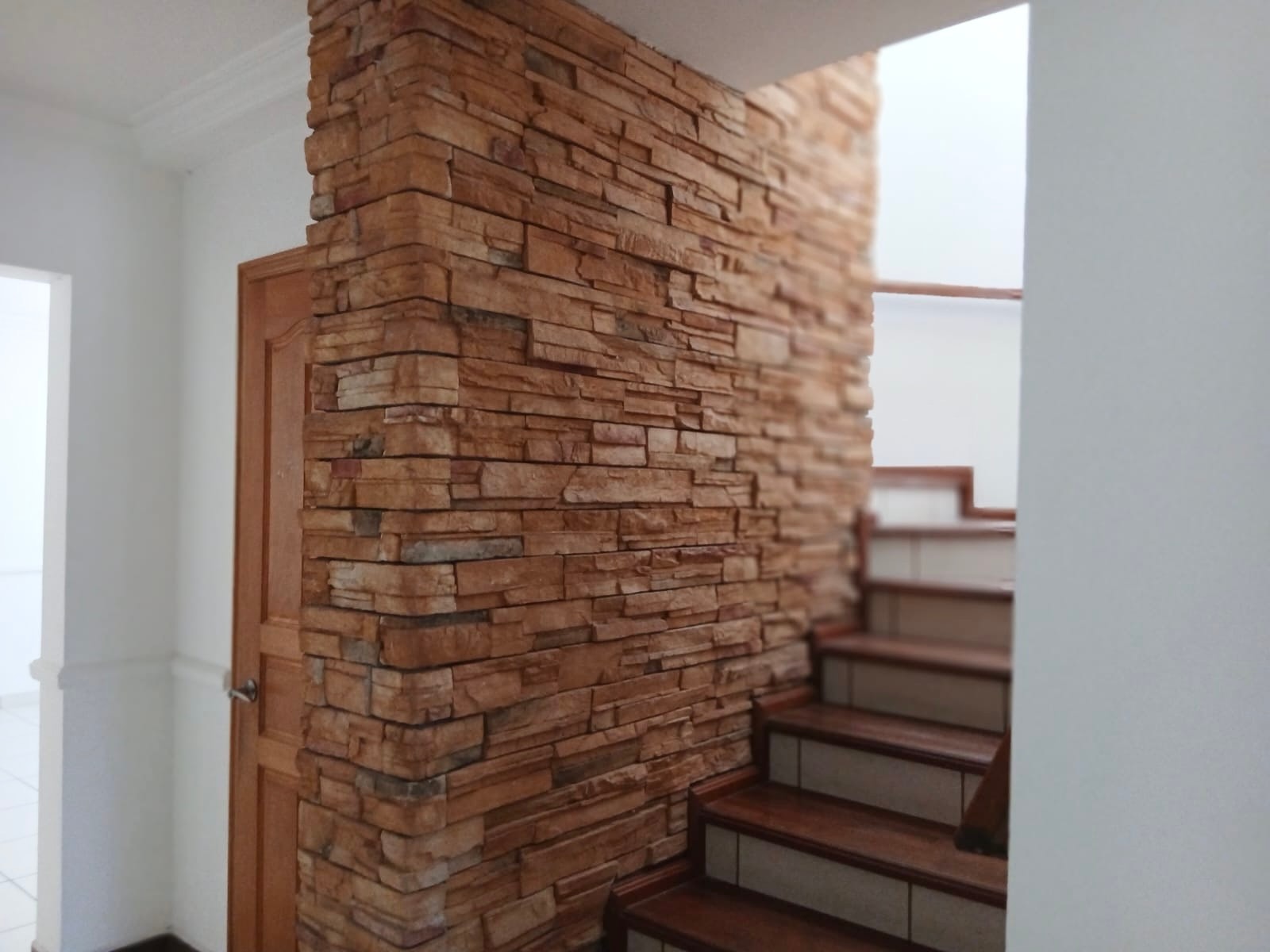 Staircase with stone wall